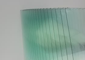 Abstract image showcasing a modern glass panel installation with reflections and a minimalistic design.